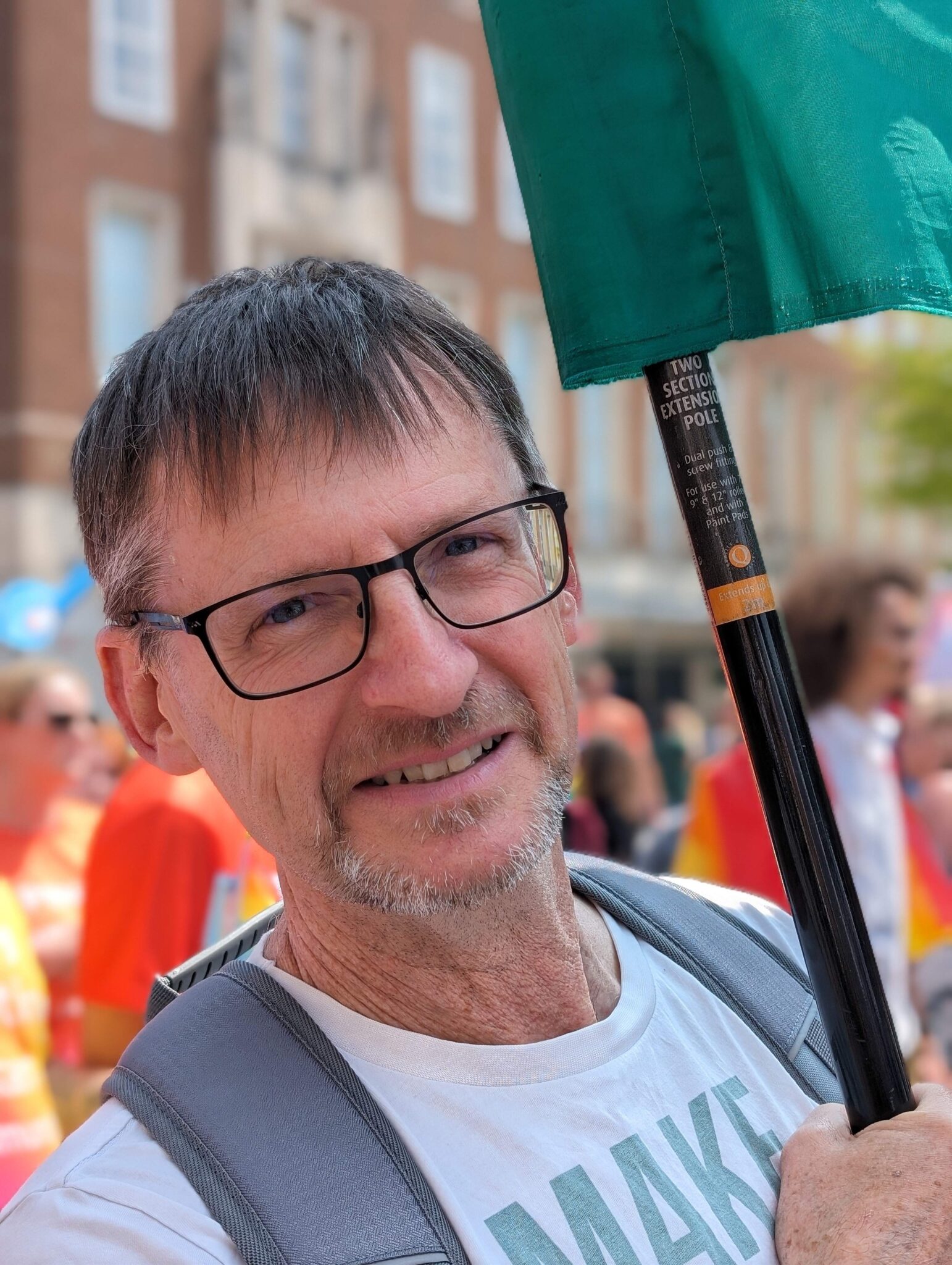 Andrew Bell carrying the Exeter Green Party Banner at Exeter Pride 2024